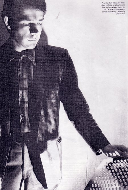 Peter Saville holding the metal door grill that inspired his and Ben Kelly's striking sleeve for the Orchestral Manoeuvres album