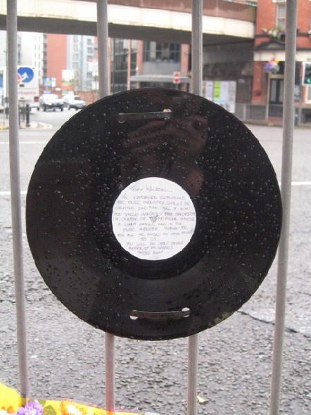12-inch record with handwritten tribute to Tony Wilson, outside the Hacienda Apartments, Manchester